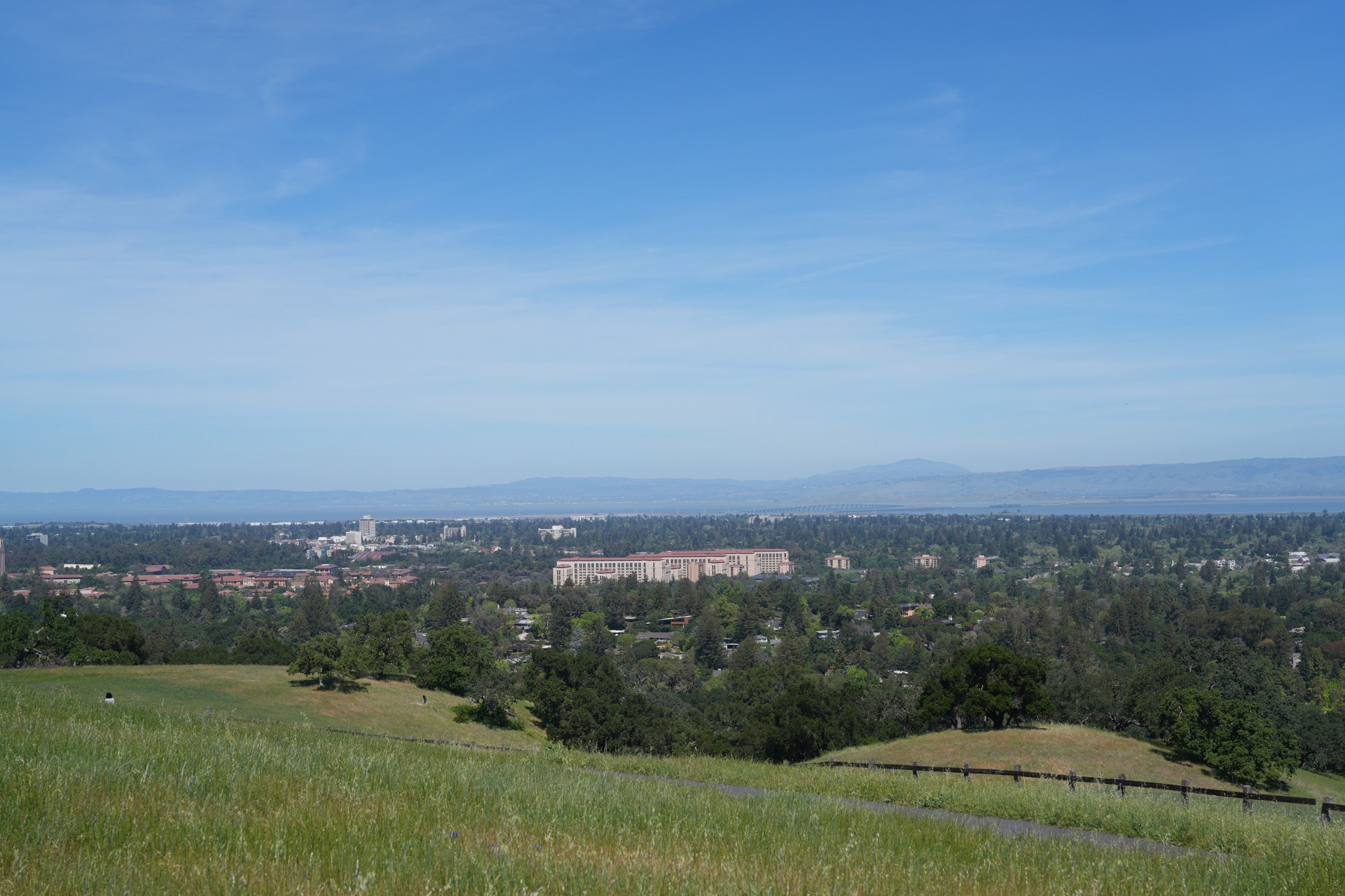 Stanford University campus and the Bay visible from the rolling green hills of the Dish trail in spring